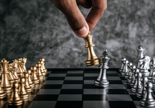 hand-man-playing-chess-business-planning-comparison-metaphor-selective-focus (1)